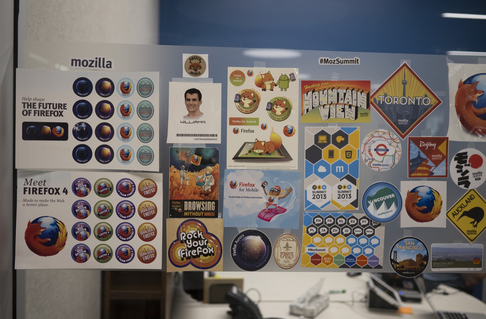 A whiteboard covered in Firefox and Mozilla stickers in the Mountain View office, 2013. Sticker culture was the cathedral's folk art.