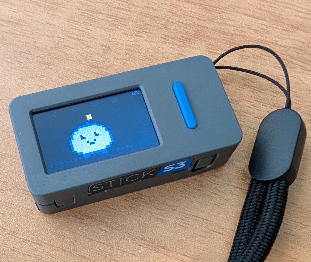 Kai's pixel face on an M5StickS3 clipped to a lanyard