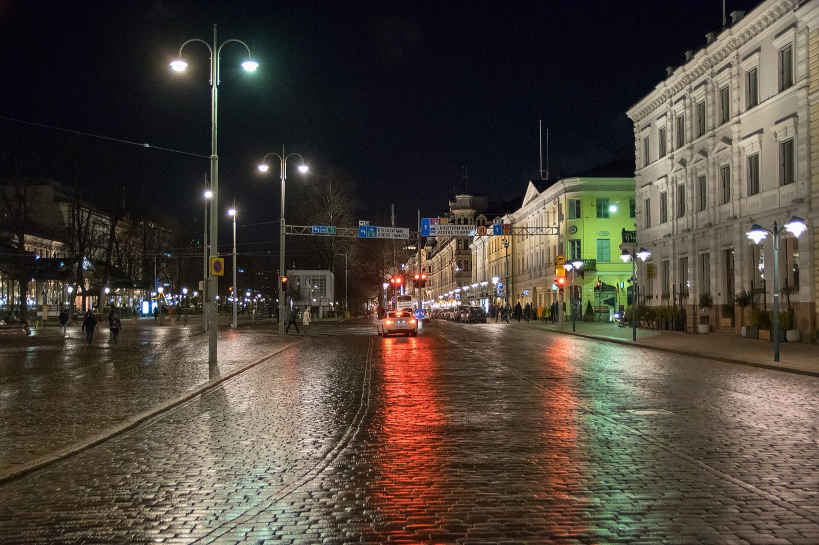 Wet cobblestones and street lamps on Pohjoisesplanadi, Helsinki, at night