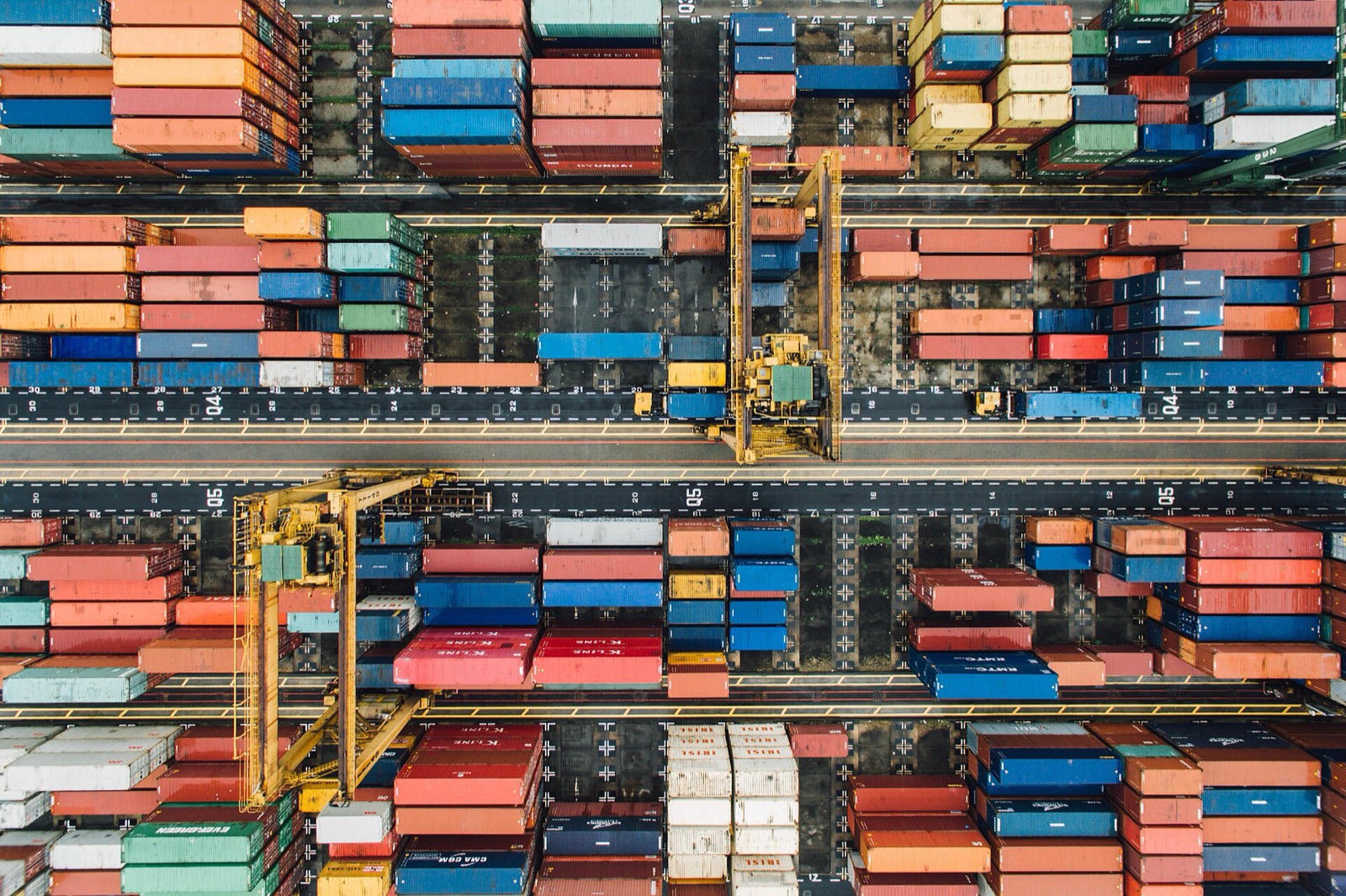Aerial view of thousands of shipping containers stacked in a port terminal