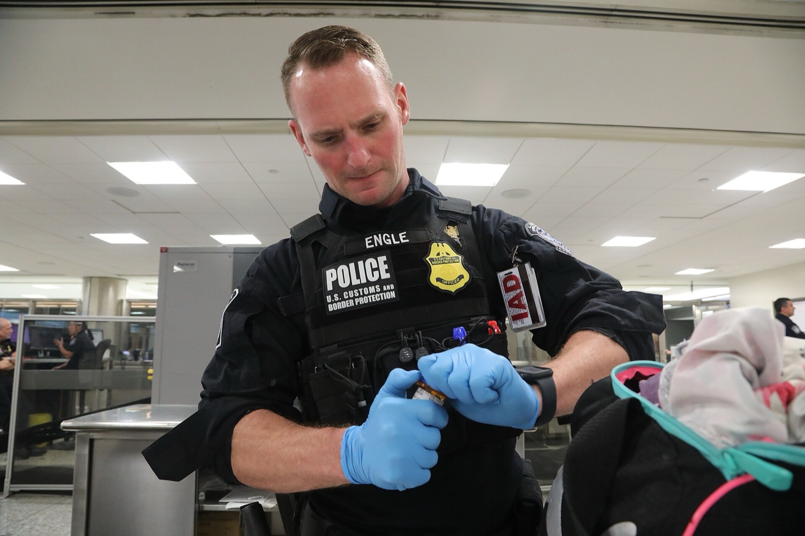 Secondary inspection: a U.S. Customs and Border Protection officer at work (Dulles, not JFK).