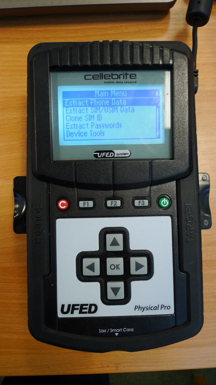 A Cellebrite UFED handheld extraction device, the kind of kit that "fell off a truck."