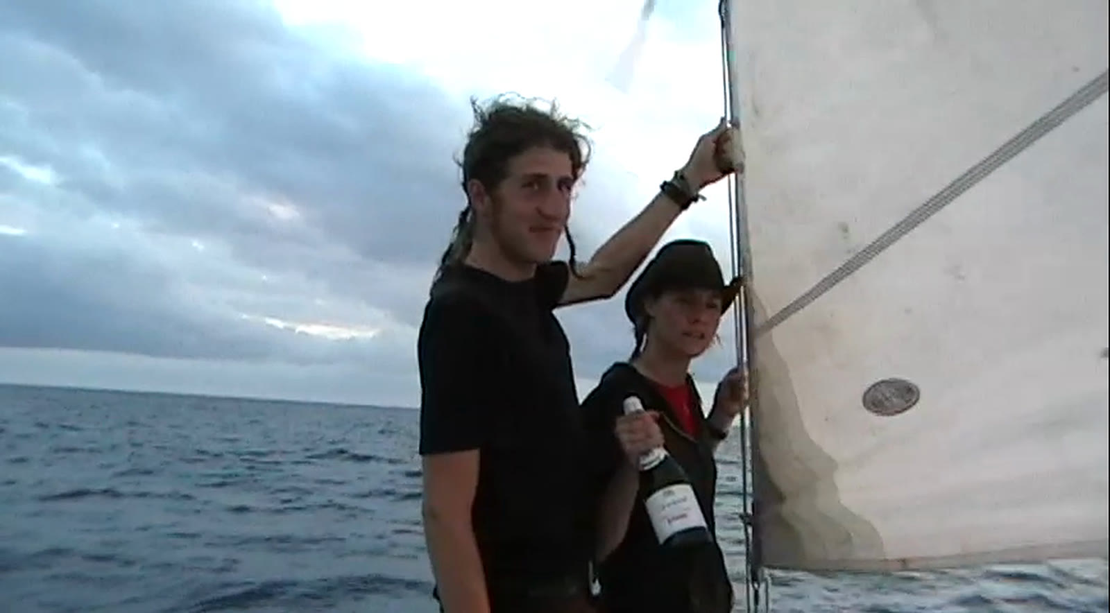 Moxie Marlinspike at the mast of S/V Pestilence, somewhere on open water, in a still from his film Hold Fast.