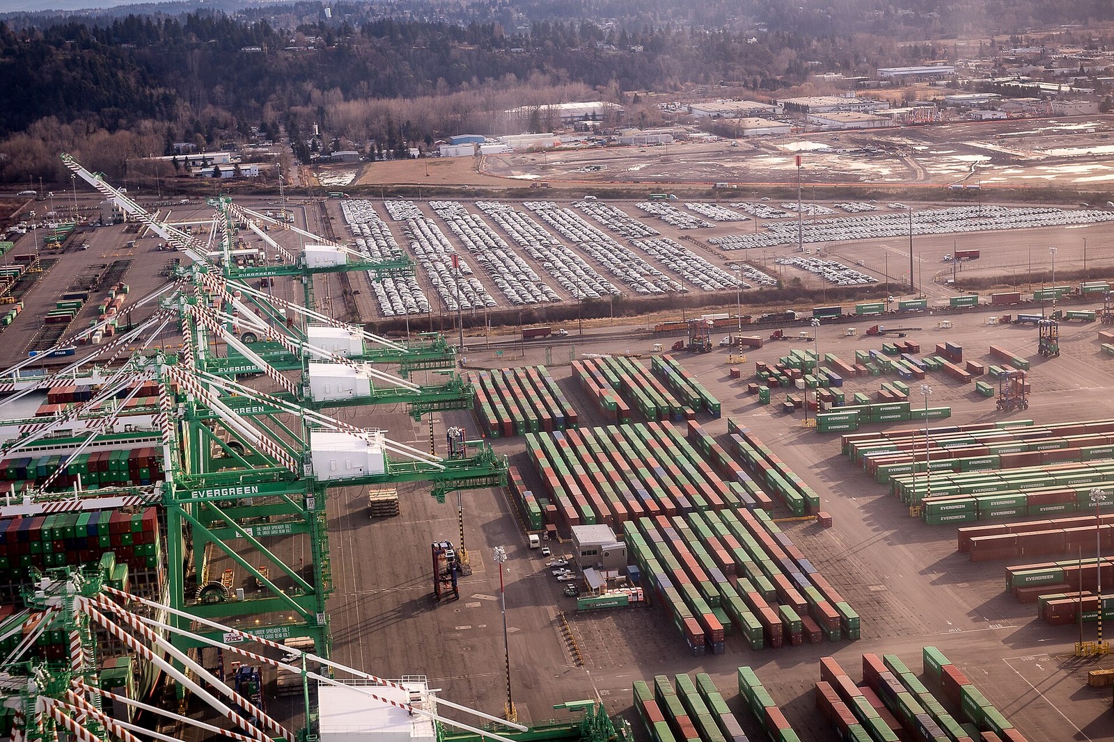 Aerial view of a container terminal stacked with shipping containers and gantry cranes