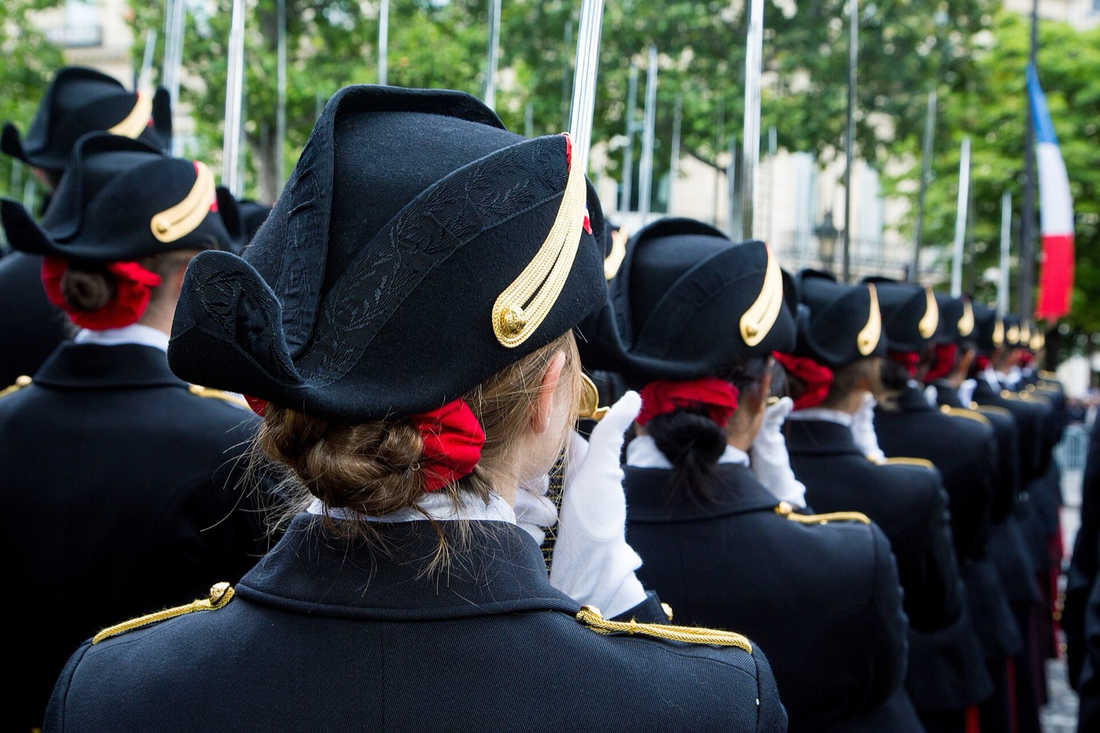 Polytechniciens in bicorne and grand uniform at the Bastille Day parade. The school that forged Bellard still marches.