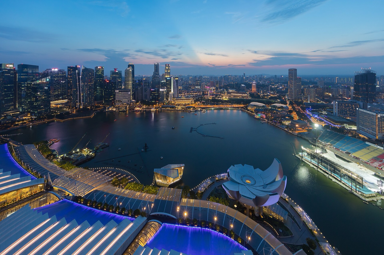 The Singapore skyline glows at dusk over Marina Bay.