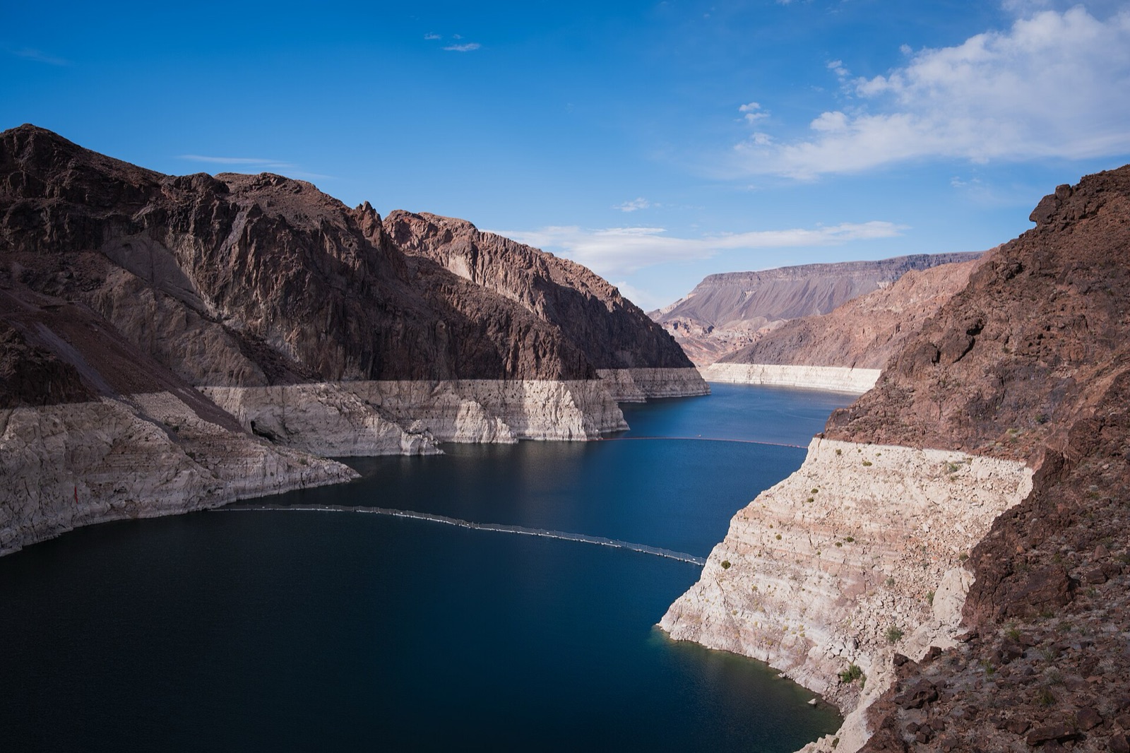 Lake Mead in Black Canyon, with a broad white mineral band ringing the canyon walls far above the current water line