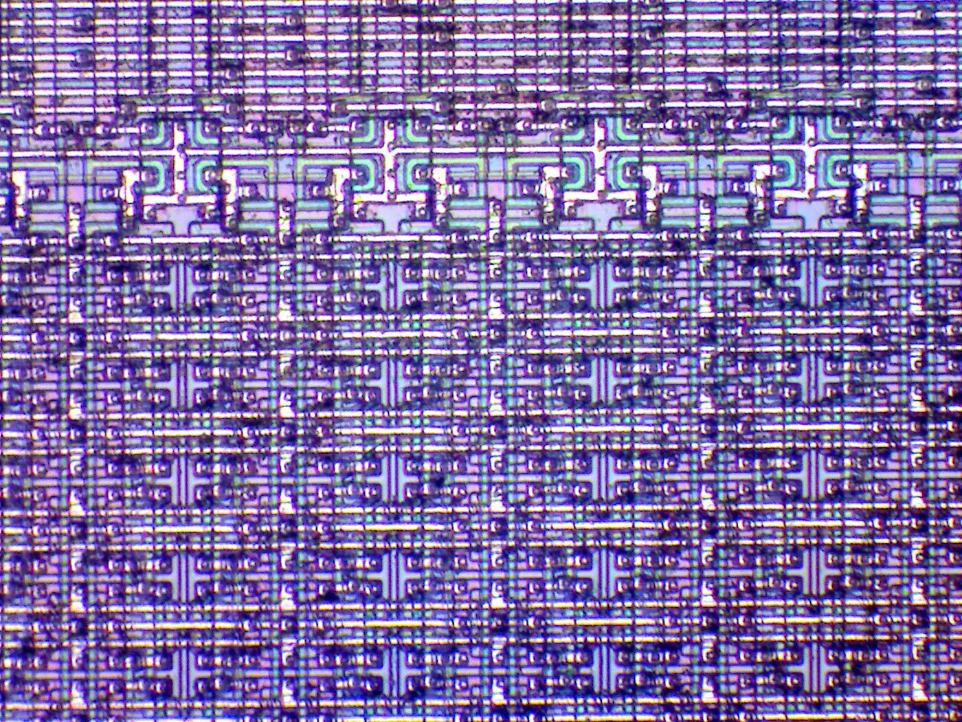 A microprocessor die under the microscope — thousands of logic gates that, until recently, only a handful of corporations knew how to build at scale.