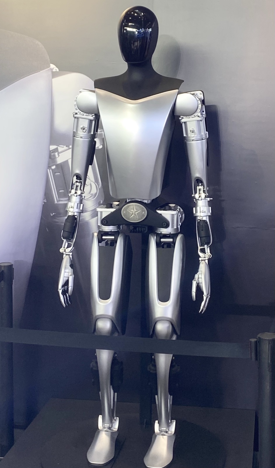 Tesla's Optimus humanoid on display. Impressive on a pedestal; still largely a research platform on the floor.