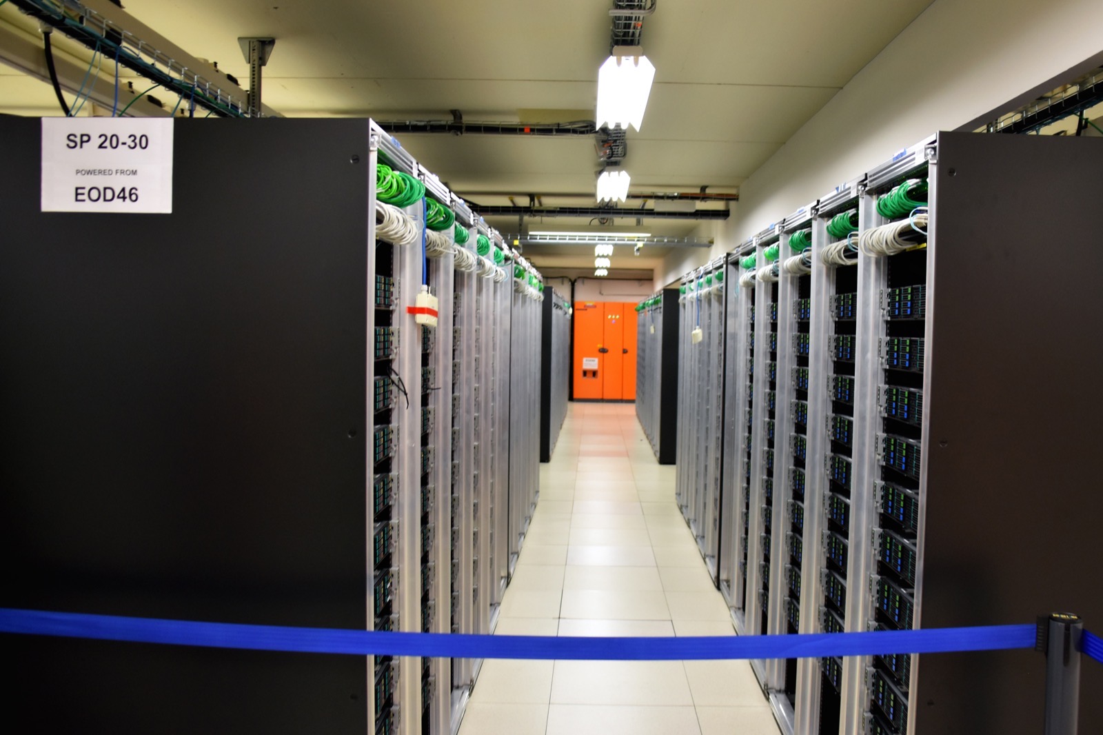The interior of a large data center, rows of servers of the kind that train modern language models
